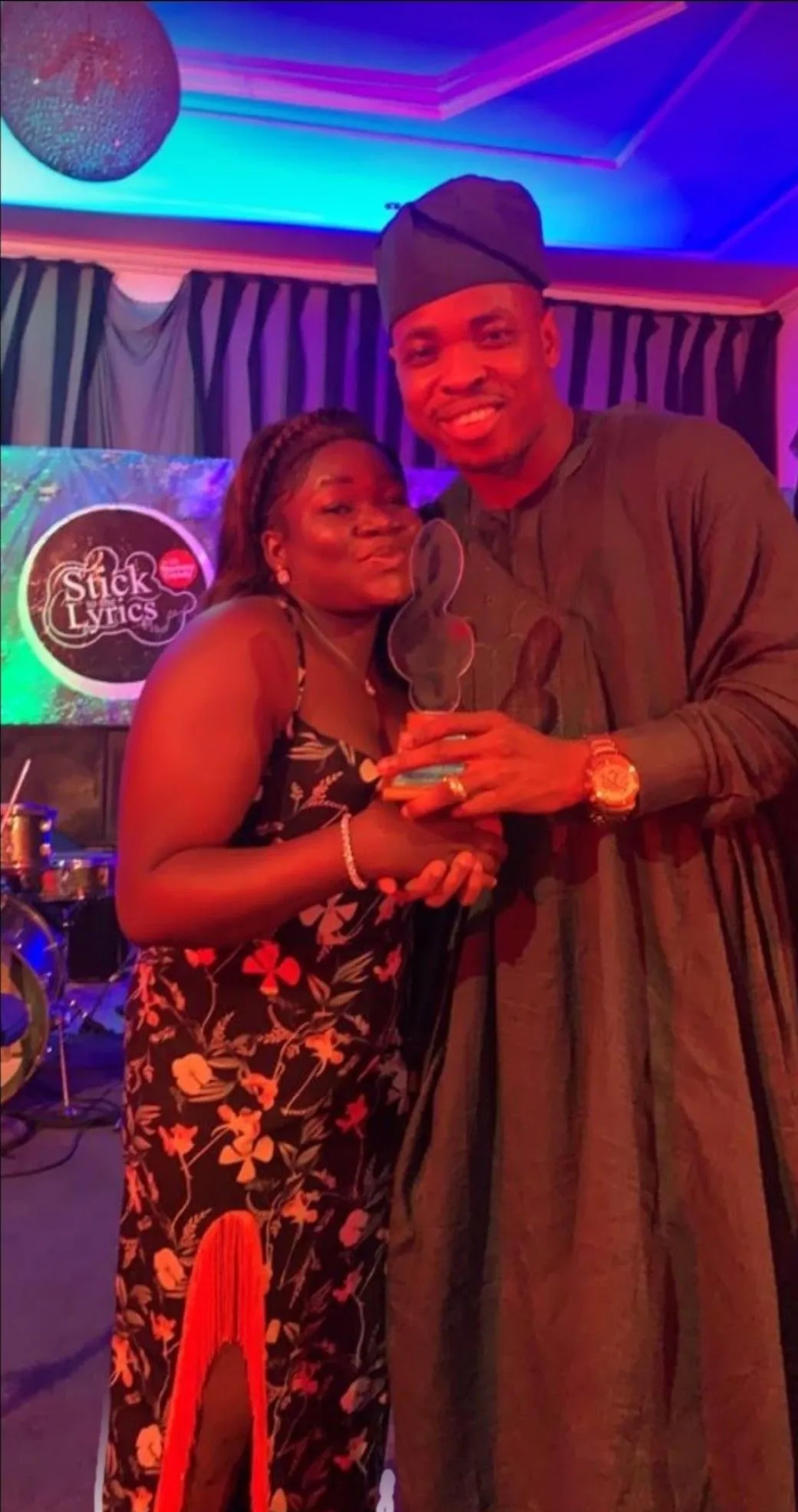 Stick to the Lyrics honoree holding a Stick to the Lyrics award