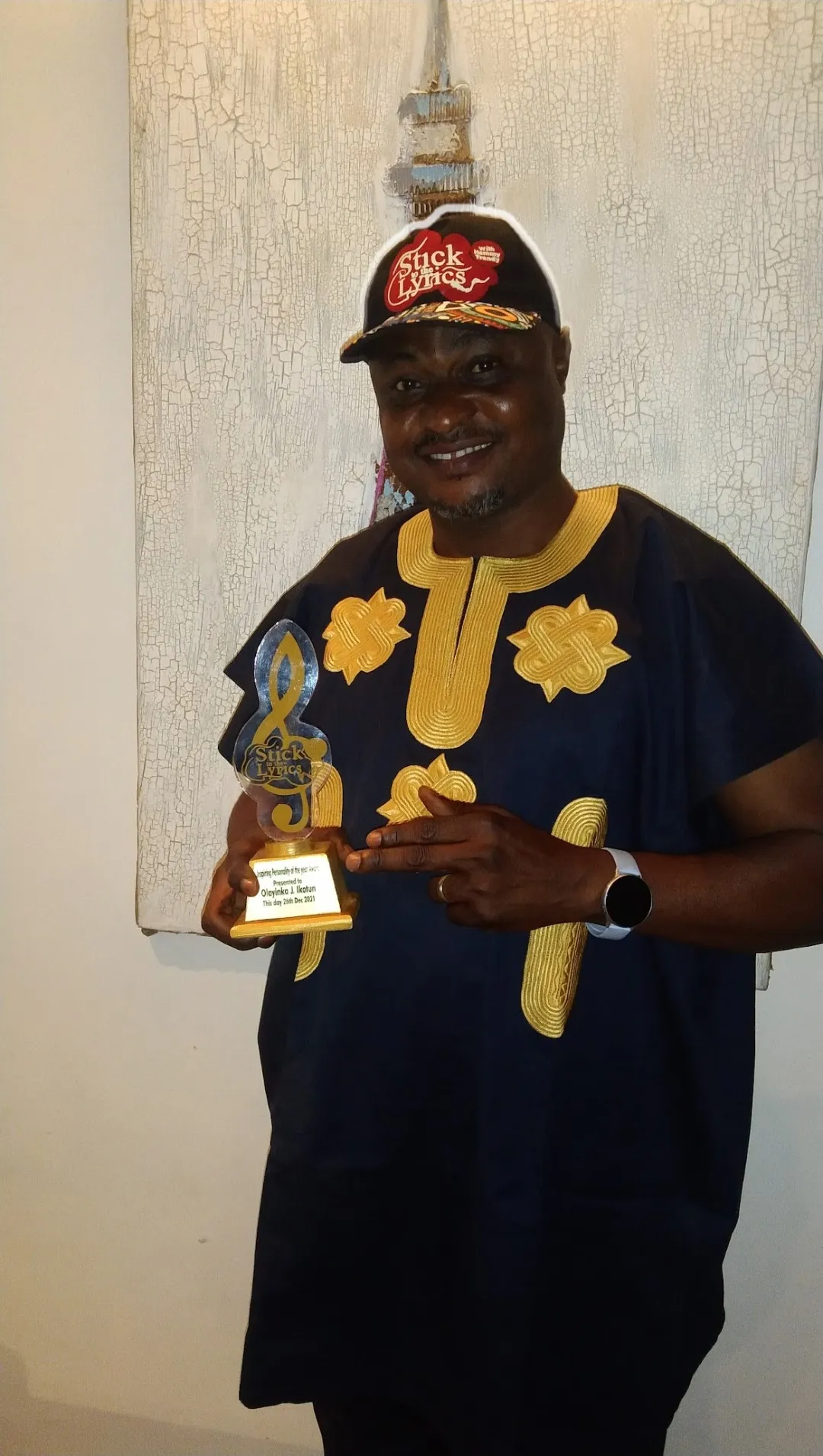 Stick to the Lyrics honoree holding a Stick to the Lyrics award