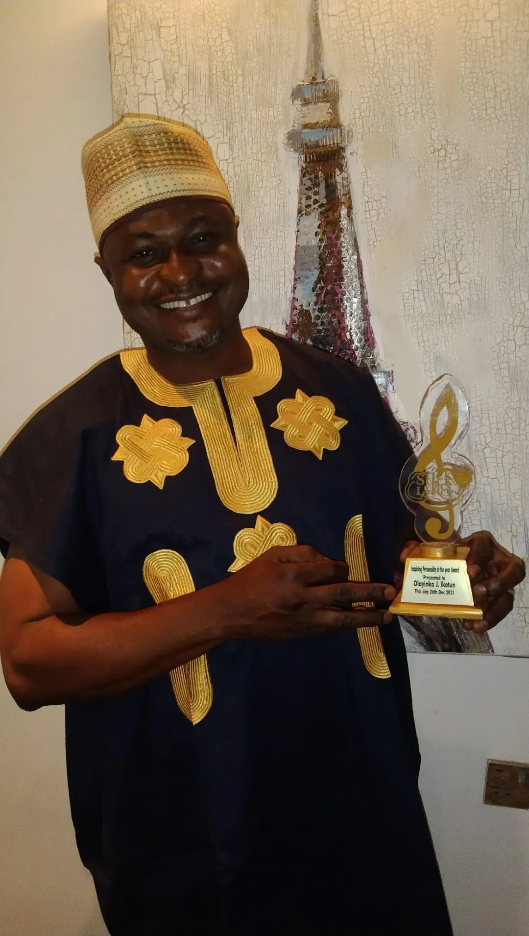 Stick to the Lyrics honoree holding a Stick to the Lyrics award